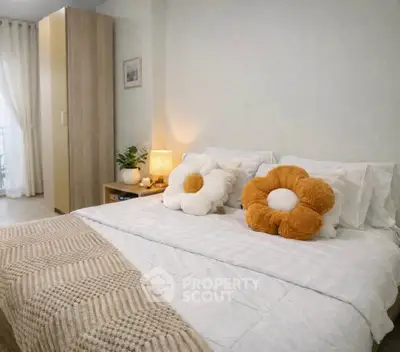 Cozy bedroom with stylish decor and plush flower pillows