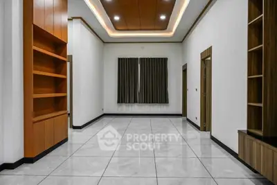 Spacious modern living room with elegant wooden shelves and tiled flooring