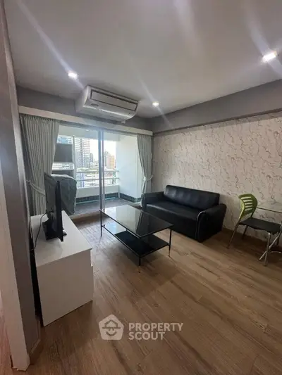 Modern living room with city view, featuring sleek furniture and large windows for natural light.
