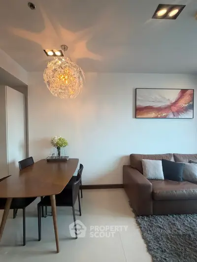 Modern living room with stylish chandelier and cozy seating area