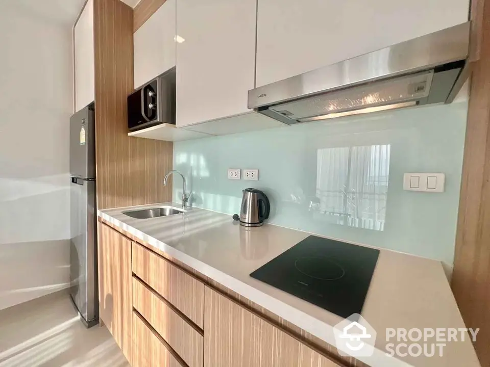 Modern kitchen with sleek cabinetry and built-in appliances in a stylish apartment.