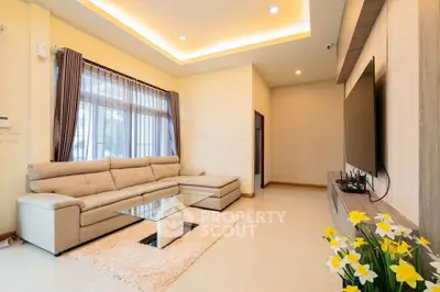 Spacious modern living room with elegant decor and large windows.