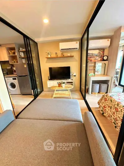 Modern apartment interior with open layout, featuring a cozy living area, kitchen, and bedroom with stylish decor.
