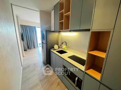 Modern kitchen with sleek cabinetry and built-in appliances in a stylish apartment.