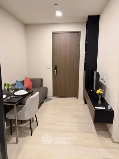 Modern living room with dining area and stylish decor in a cozy apartment.