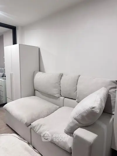 Cozy living room with plush white sofa and modern decor