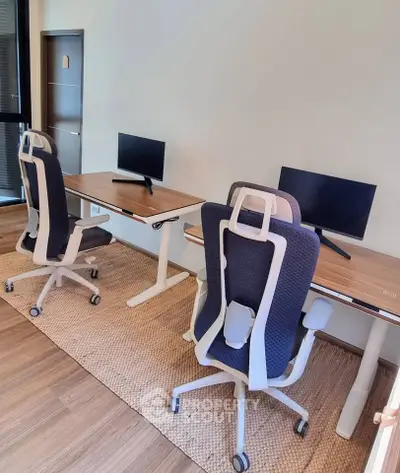 Modern home office with ergonomic chairs and dual desks, perfect for productivity.
