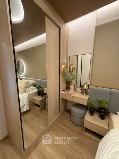 Modern bedroom with stylish decor and mirrored wardrobe