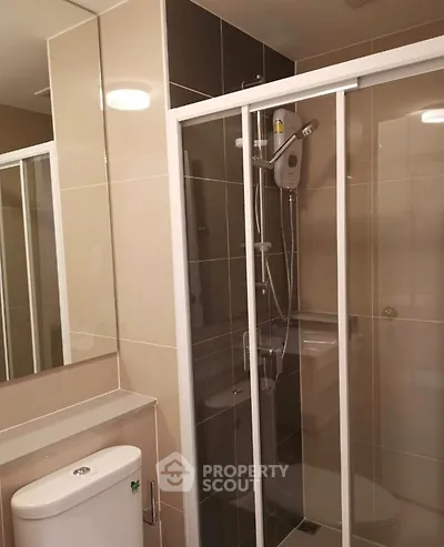 Modern bathroom with sleek shower enclosure and contemporary fixtures.