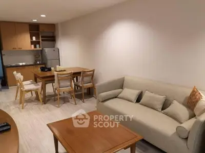 Cozy living room with dining area and modern kitchen in open layout apartment.