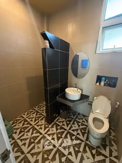 Modern bathroom with stylish tile flooring and sleek fixtures