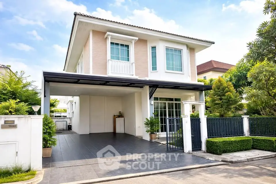 Charming two-story house with spacious driveway and lush greenery, perfect for family living.