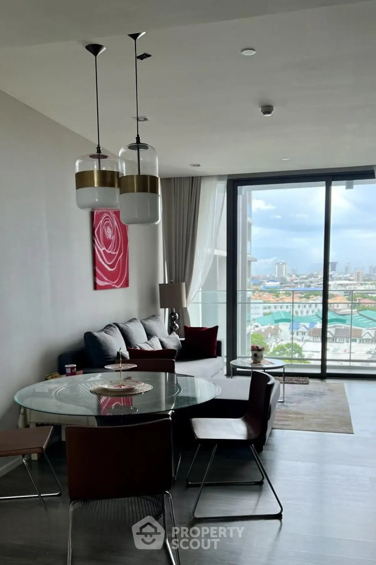 Modern living room with glass table and city view balcony in luxury apartment