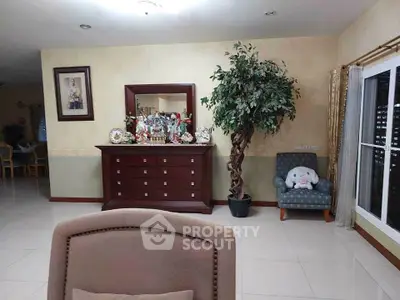 Spacious living room with elegant decor and large mirror