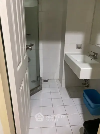 Compact bathroom with modern fixtures and glass shower enclosure