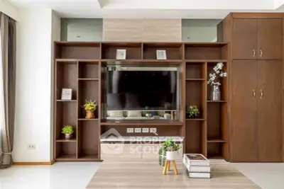 Modern living room with built-in wooden entertainment center and stylish decor