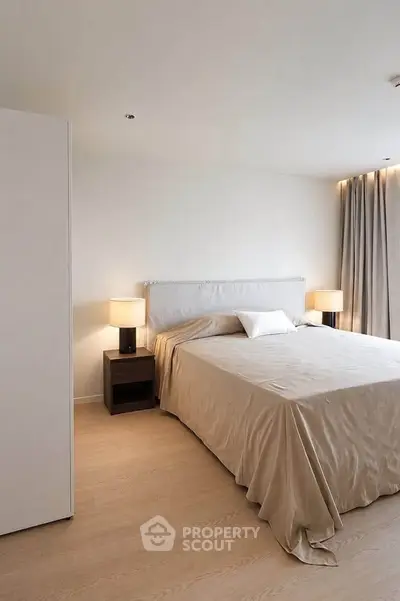 Elegant bedroom with neutral tones, featuring a cozy bed and ambient lighting for a serene atmosphere.