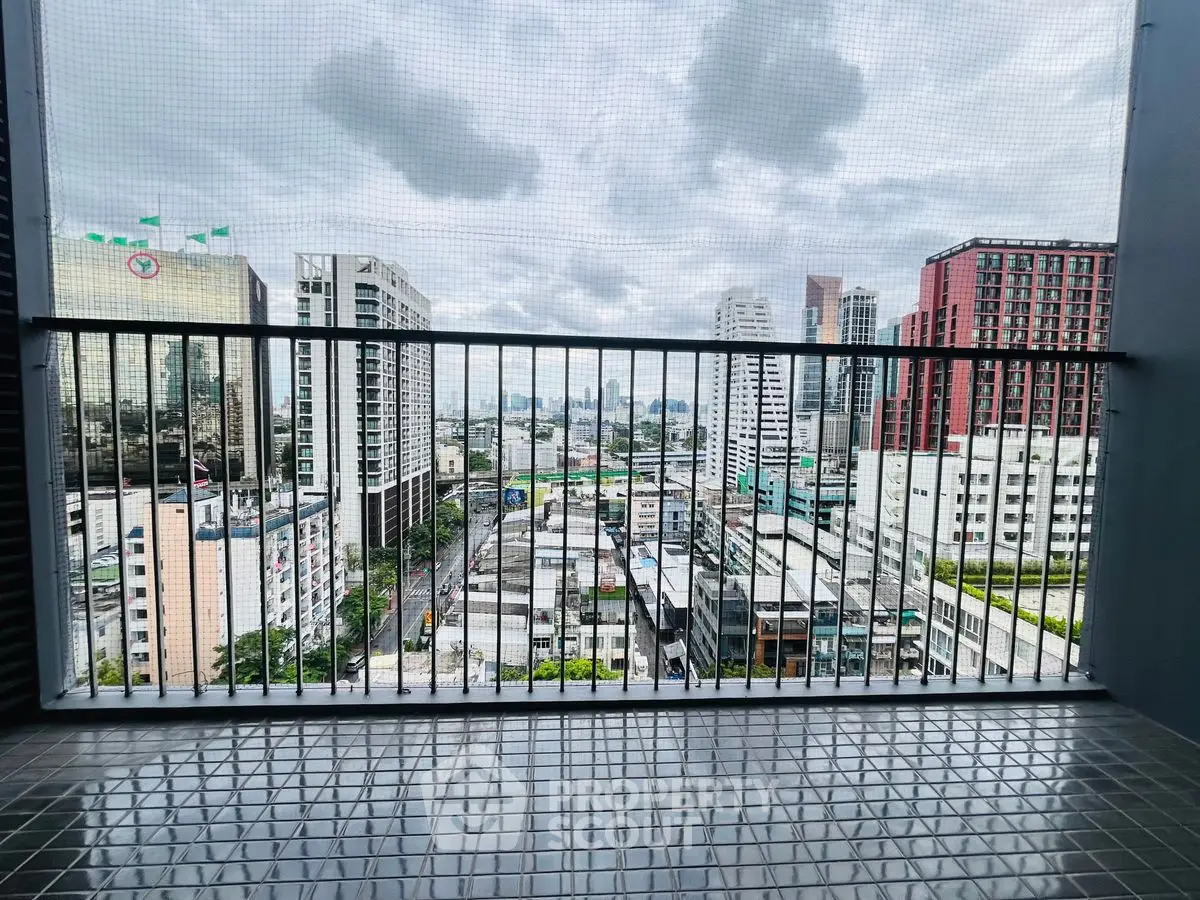 Stunning city view from high-rise balcony with modern railing.