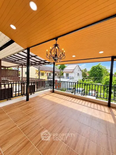 Spacious balcony with elegant chandelier and scenic neighborhood view