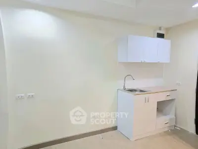 Compact kitchen area with modern cabinetry and sink in a minimalist design.