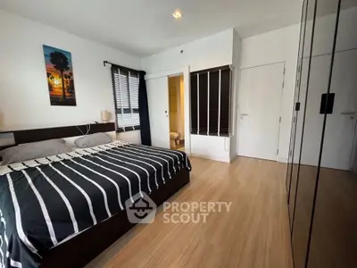 Modern bedroom with stylish decor and ample natural light