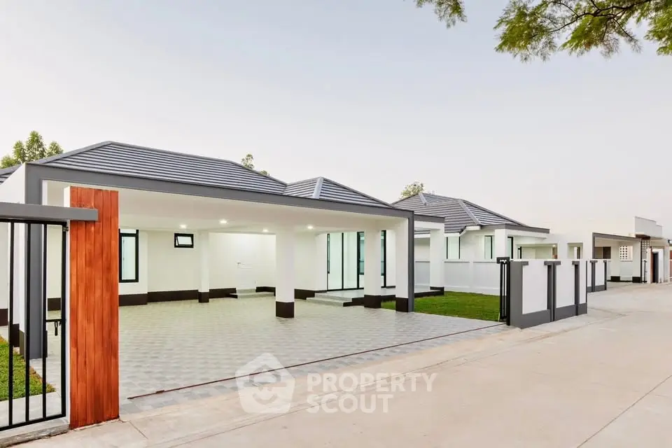 Modern single-story homes with sleek design and spacious driveways.