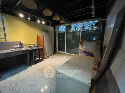Spacious commercial space with modern lighting and large windows for lease.
