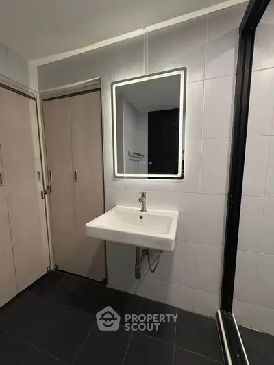 Modern bathroom with illuminated mirror and sleek sink design