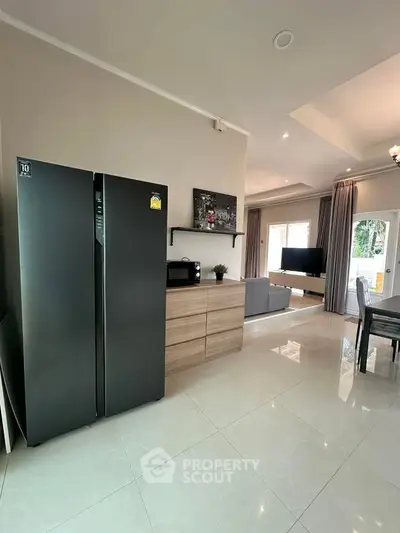 Spacious modern living room with sleek kitchen appliances and elegant decor