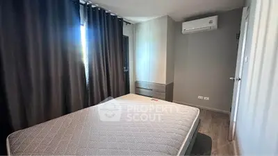 Modern bedroom with air conditioning and stylish curtains