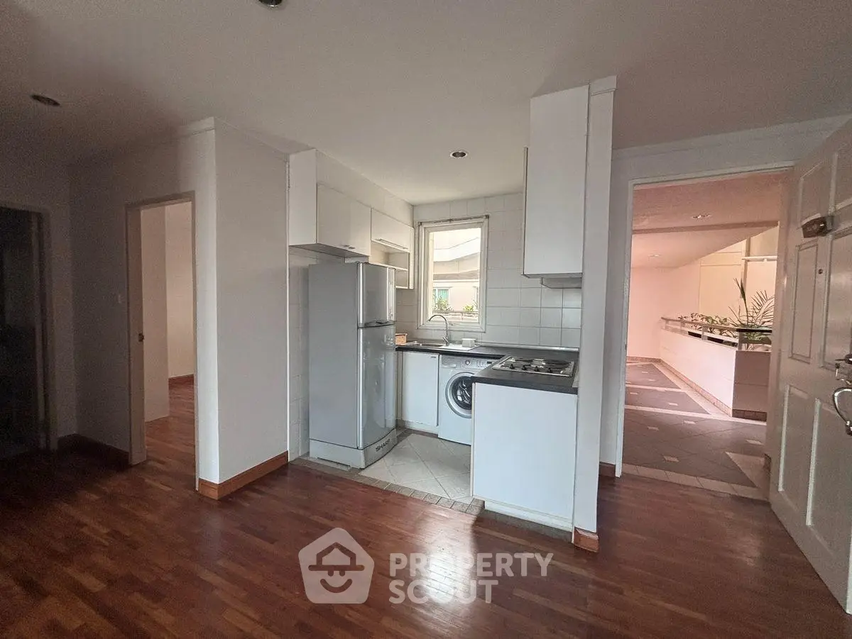 Cozy kitchen with wooden flooring and modern appliances in a stylish apartment