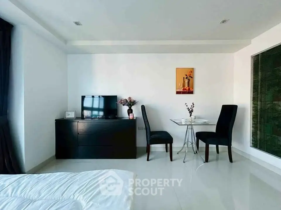 Modern bedroom with sleek furniture and elegant dining area