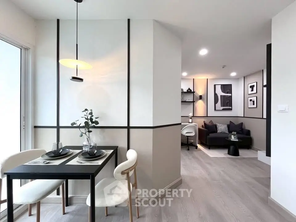 Modern open-plan living and dining area with stylish decor and natural light.
