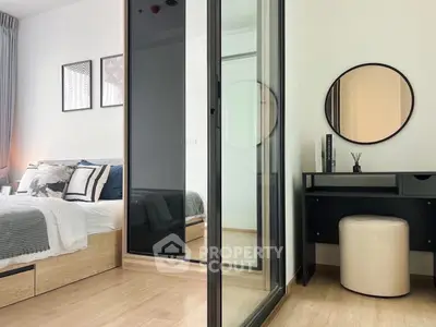 Modern bedroom with stylish decor and mirrored wardrobe