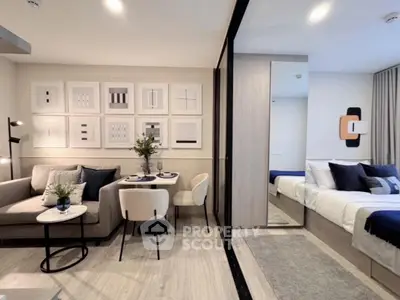 Modern open-plan living room and bedroom with stylish decor and neutral tones