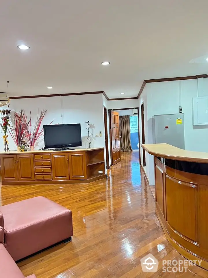 Spacious living room with wooden flooring and modern entertainment setup