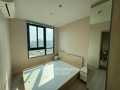 Modern bedroom with city view, featuring large window and minimalist design.