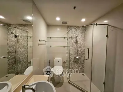 Modern bathroom with glass shower and stylish tile accents