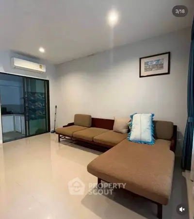 Spacious living room with modern sofa and air conditioning in a stylish apartment.