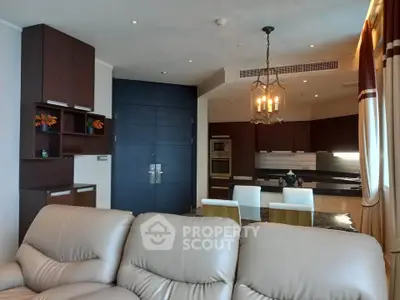 Luxurious open-layout living room with modern kitchen and elegant decor