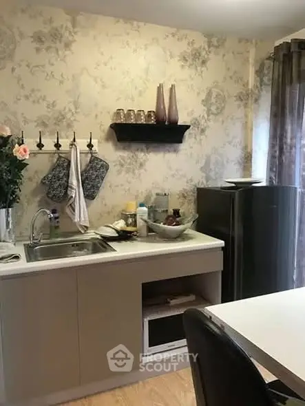 Charming kitchen with floral wallpaper and modern appliances