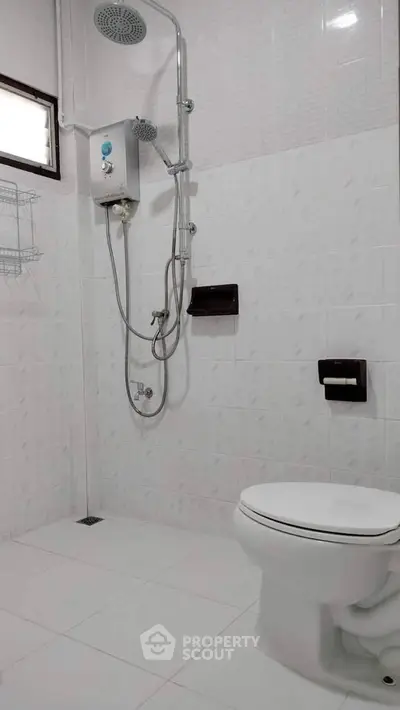 Modern bathroom with shower and white tiled walls