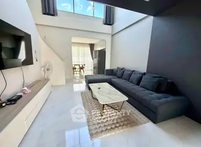 Spacious modern living room with high ceilings and elegant decor
