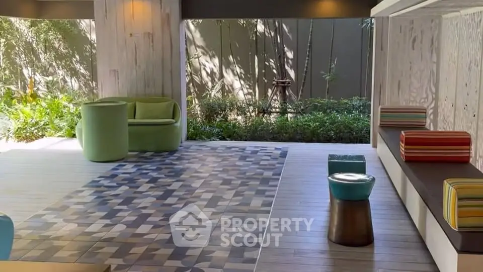 Stylish modern outdoor lounge with vibrant seating and geometric rug