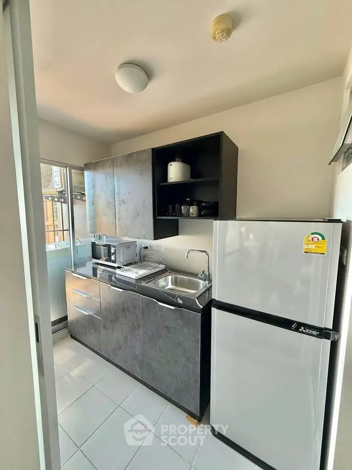 Modern compact kitchen with sleek cabinets and appliances in urban apartment