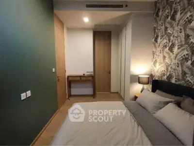 Cozy bedroom with modern decor and stylish wallpaper, perfect for relaxation and comfort.