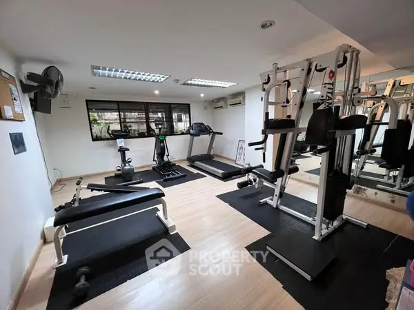 Modern gym with state-of-the-art fitness equipment and bright lighting.