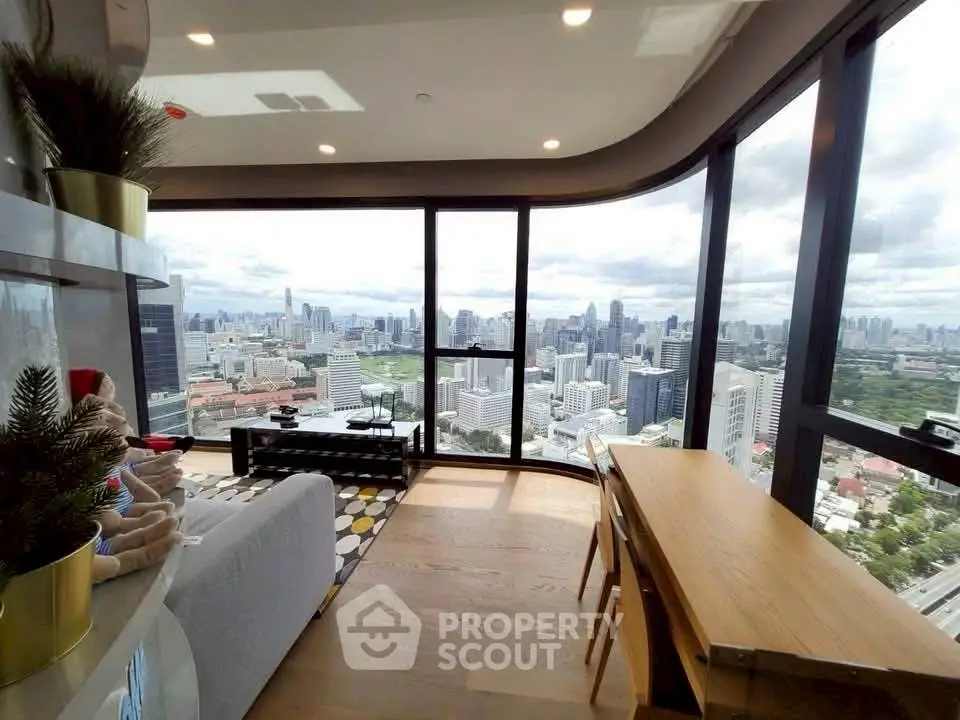 Luxurious high-rise living room with panoramic city views and modern decor.