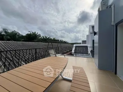 Spacious balcony with modern design and scenic view, perfect for relaxation and outdoor dining.