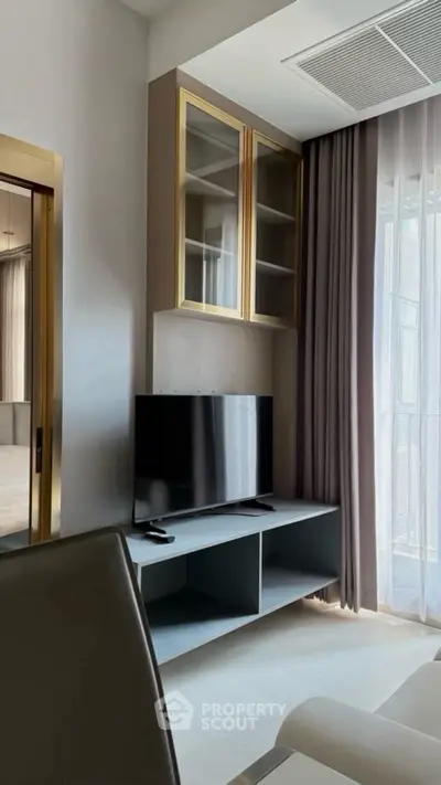 Modern living room with sleek TV unit and elegant curtains